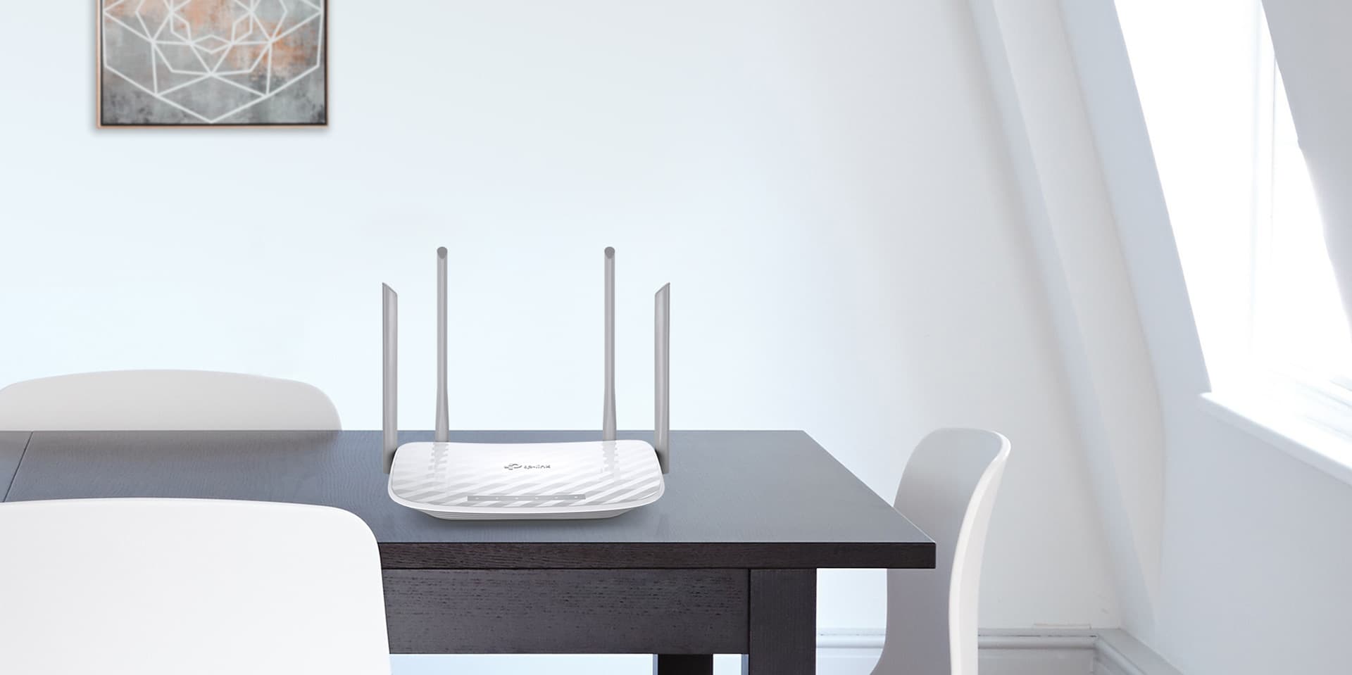 TP-LINK Archer C50 on a tabletop in a modern home setting